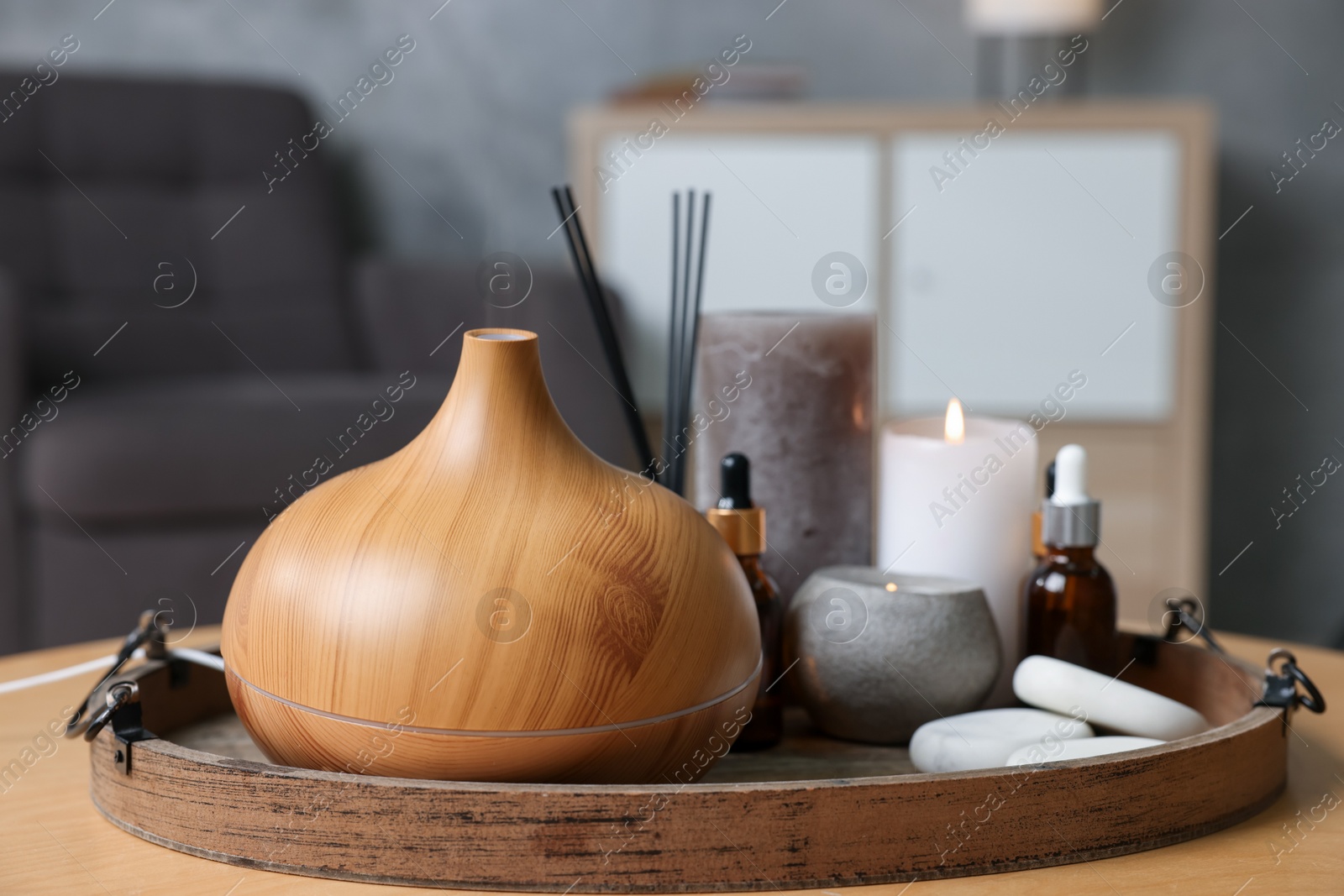 Spa composition with burning candles on wooden table indoors, closeup Photo of Spa composition with burning candles on wooden table indoors, closeup