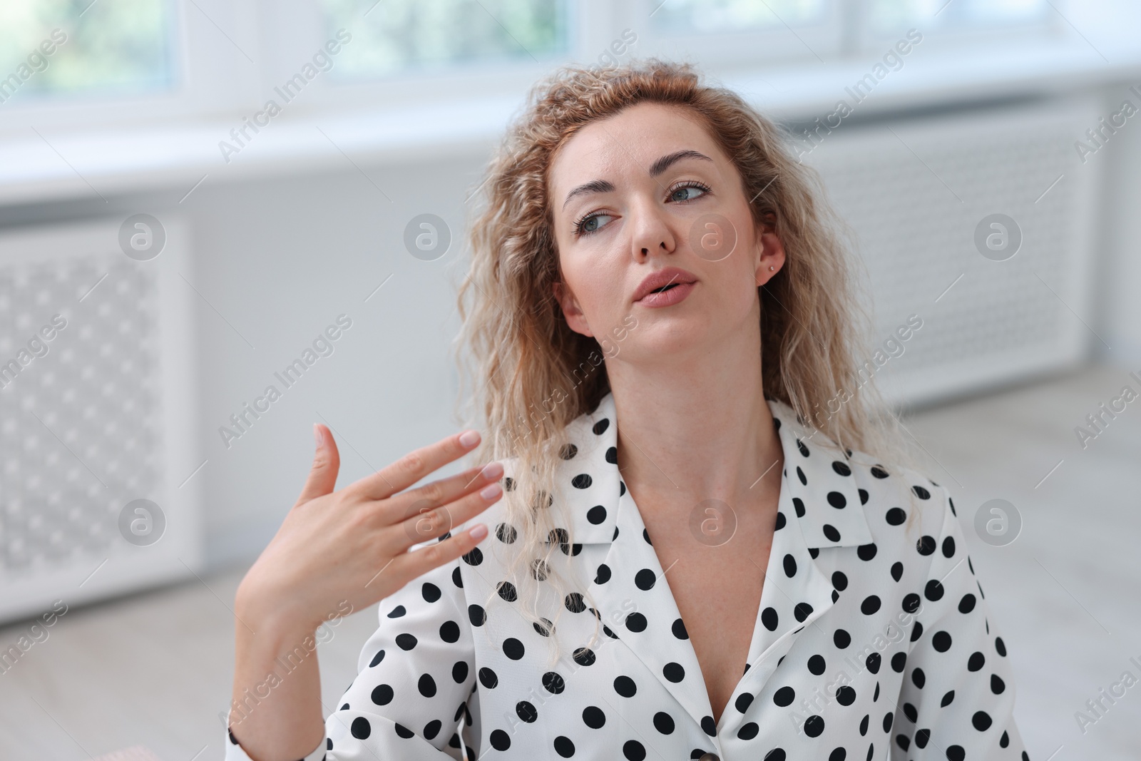 Photo of Air conditioning. Woman suffering from heat at workplace in office