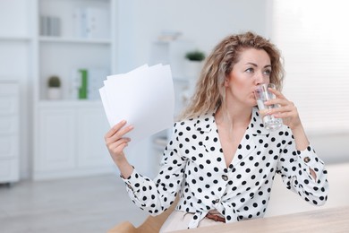 Photo of Air conditioning. Woman suffering from heat at workplace in office