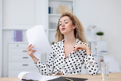 Photo of Air conditioning. Woman suffering from heat at workplace in office