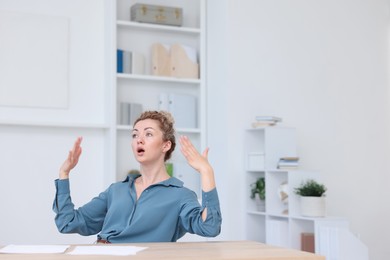 Photo of Air conditioning. Woman suffering from heat at workplace in office