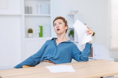 Photo of Air conditioning. Woman suffering from heat at workplace in office