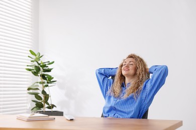 Photo of Woman sitting at workplace in office with air conditioning