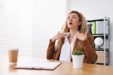 Photo of Air conditioning. Woman suffering from heat at workplace in office