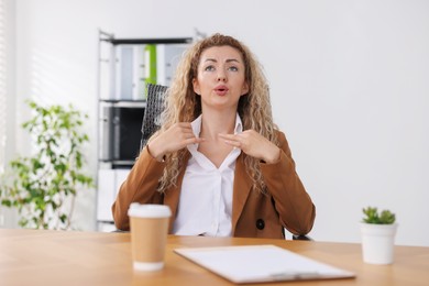 Photo of Air conditioning. Woman suffering from heat at workplace in office