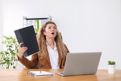 Photo of Air conditioning. Woman suffering from heat at workplace in office