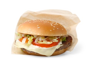 Photo of One delicious burger with cheese, tomato, lettuce and patty in takeaway package isolated on white. Tasty fast food