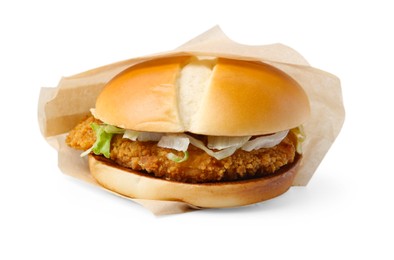 Photo of One delicious burger with lettuce and deep fried patty in takeaway package isolated on white. Tasty fast food