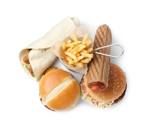 Photo of Delicious burgers, French fries, hot dog and wrap isolated on white, top view. Tasty fast food