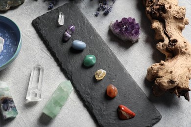 Photo of Chakra gemstones on light table, flat lay