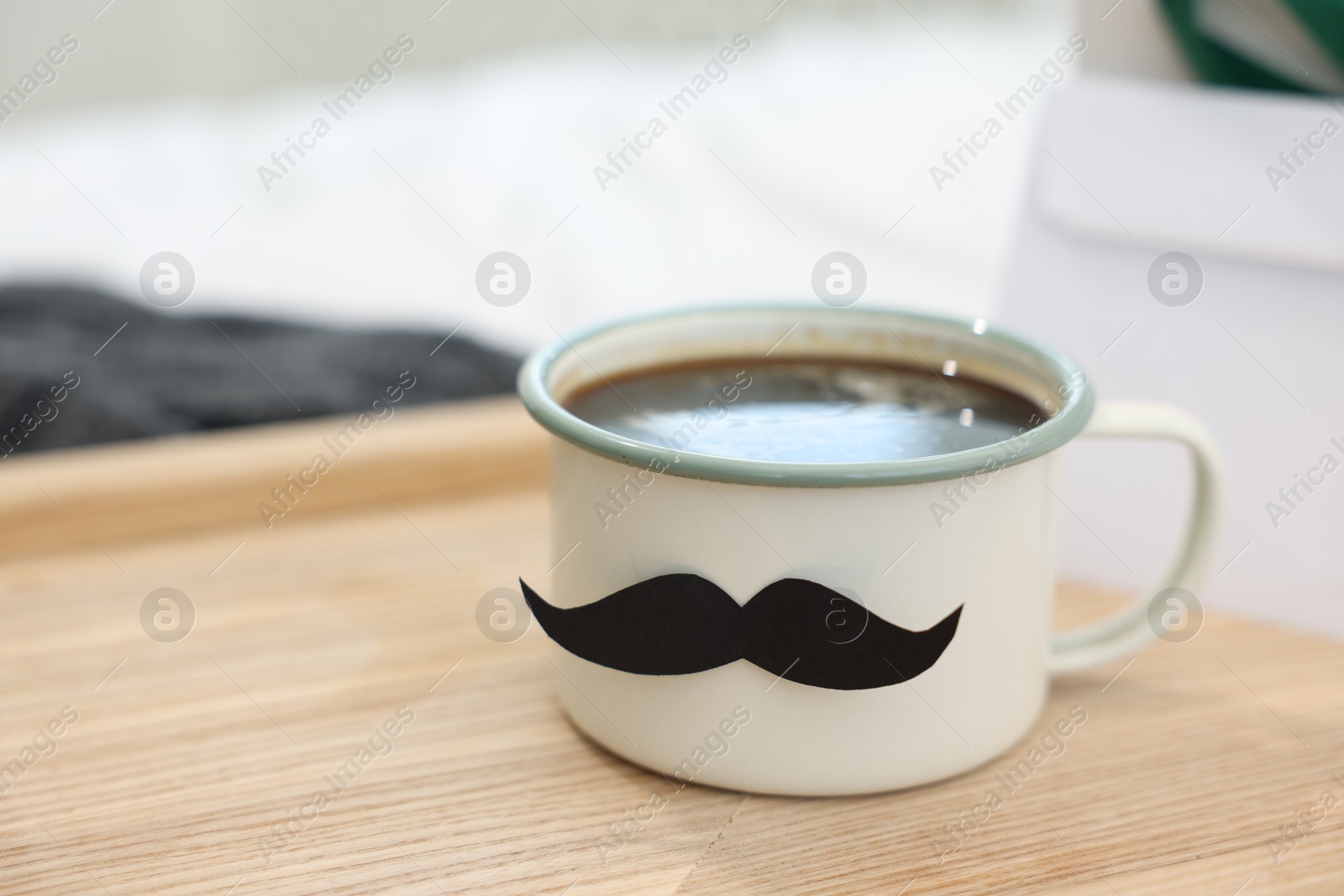 Happy Father's Day. Cup with mustache on bed at home, closeup. Space for text Photo of Happy Father's Day. Cup with mustache on bed at home, closeup. Space for text