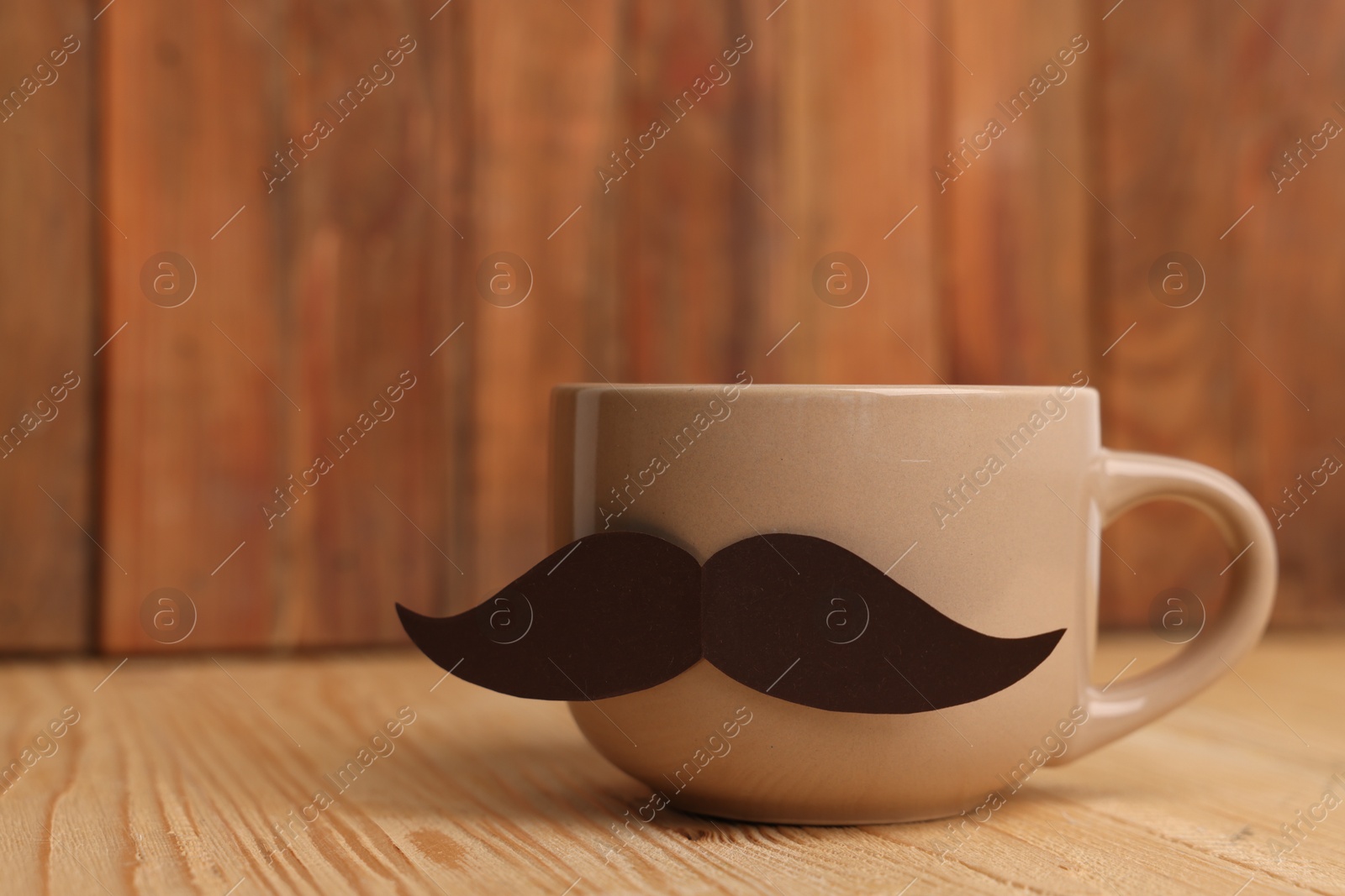 Happy Father's Day. Cup with mustache on wooden table, closeup. Space for text Photo of Happy Father's Day. Cup with mustache on wooden table, closeup. Space for text