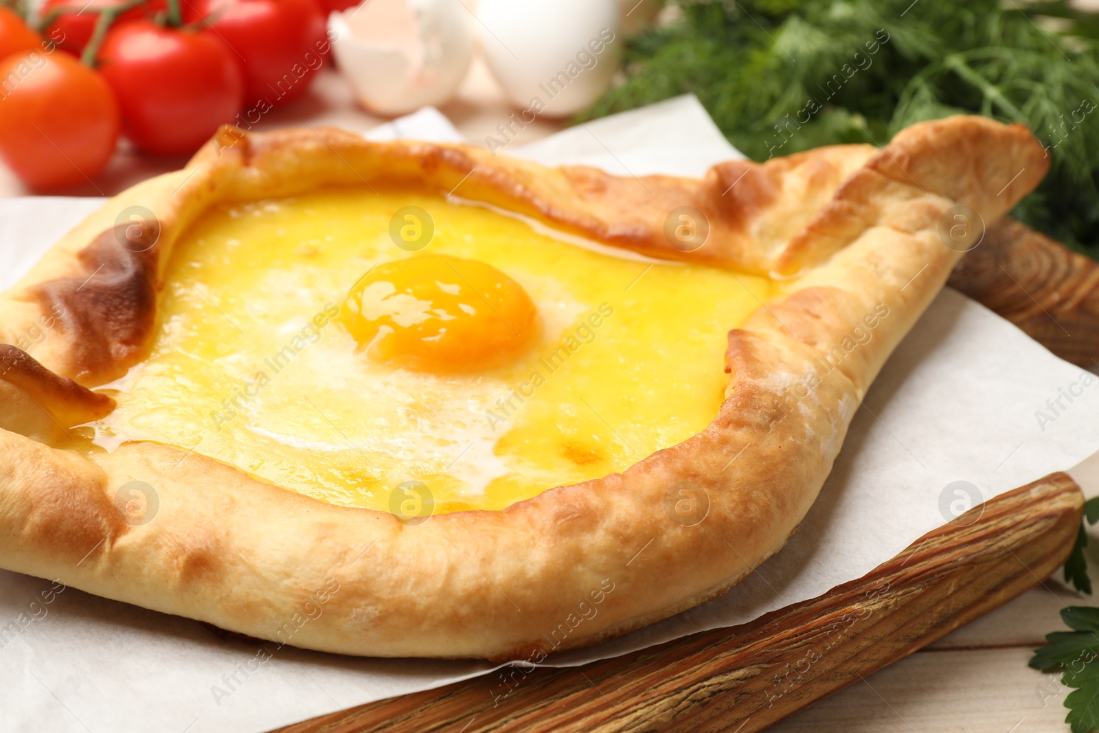 Tasty khachapuri with cheese and egg served on table, closeup Photo of Tasty khachapuri with cheese and egg served on table, closeup
