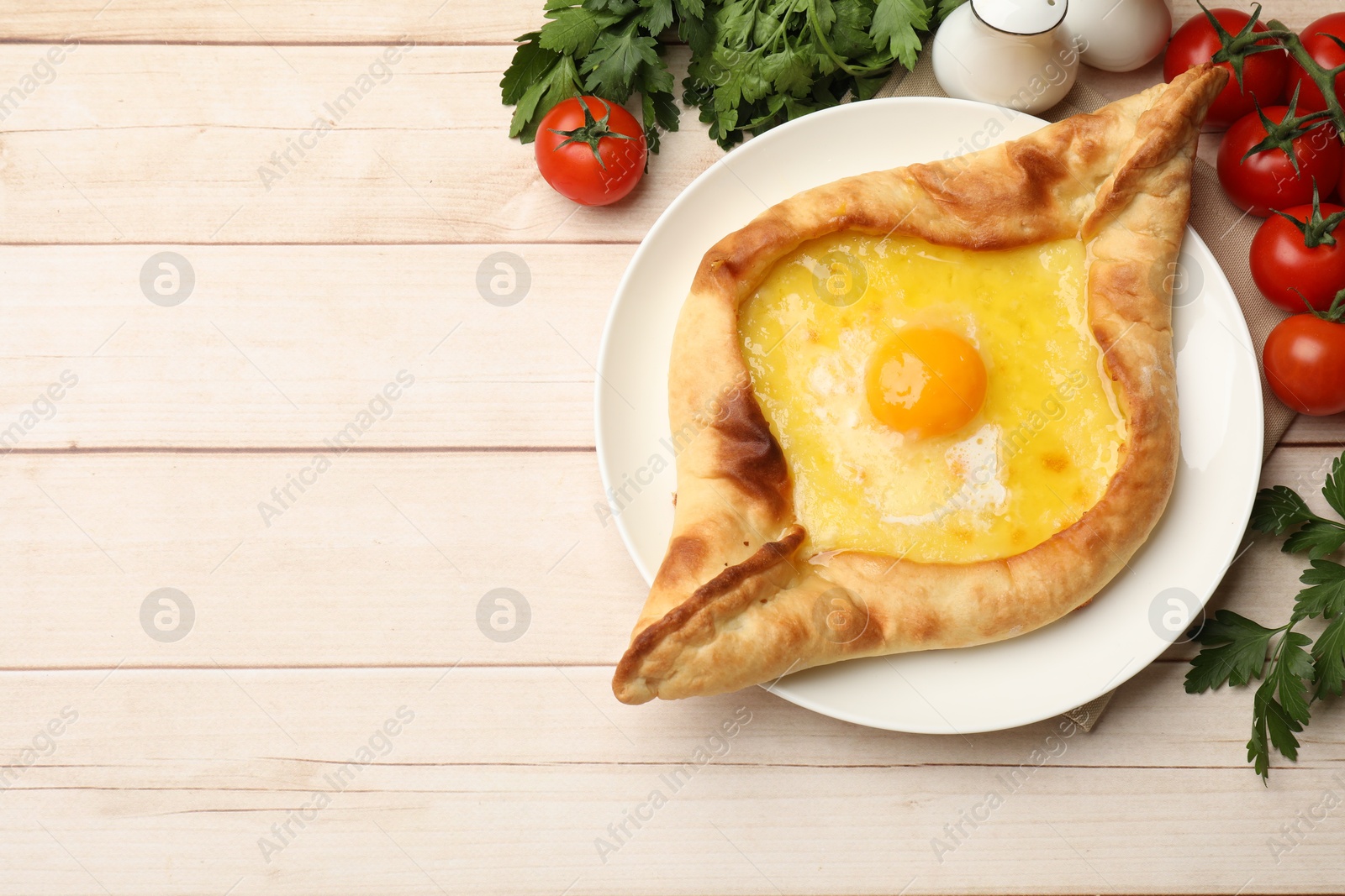 Tasty khachapuri with cheese and egg served on wooden table, flat lay. Space for text Photo of Tasty khachapuri with cheese and egg served on wooden table, flat lay. Space for text
