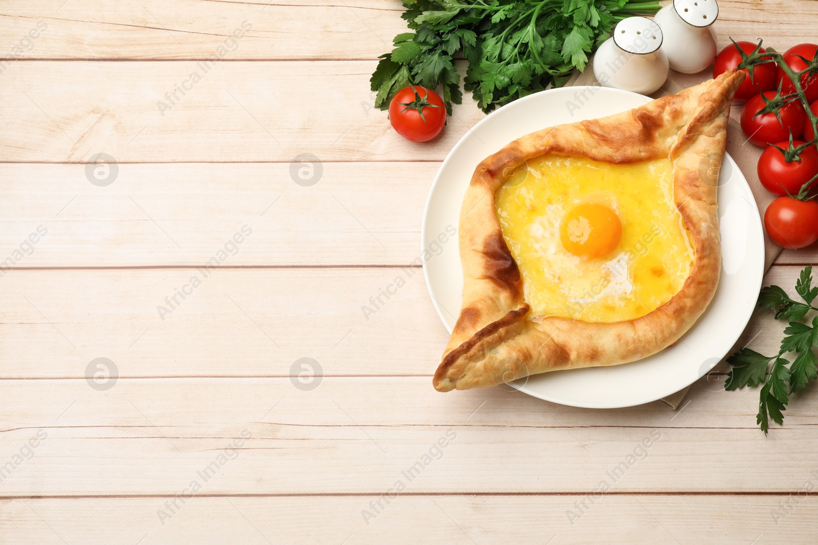 Tasty khachapuri with cheese and egg served on wooden table, flat lay. Space for text Photo of Tasty khachapuri with cheese and egg served on wooden table, flat lay. Space for text