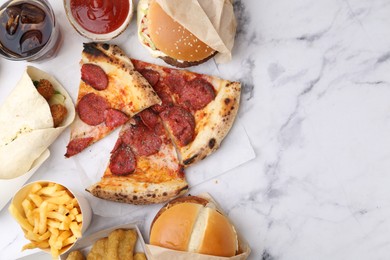 Photo of Different delicious fast food and soda drink on white marble table, flat lay