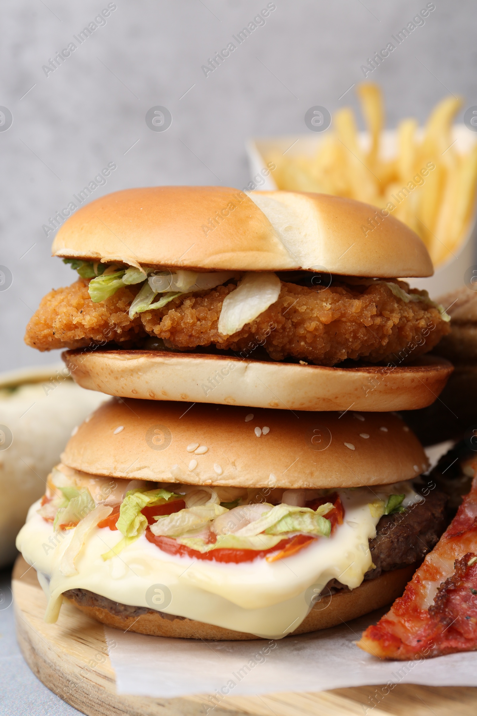 Different delicious fast food on table, closeup Photo of Different delicious fast food on table, closeup