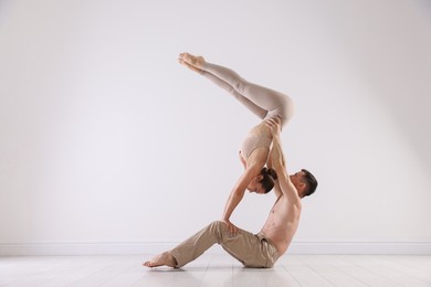 Photo of Couple of professional dancers training in studio. Space for text