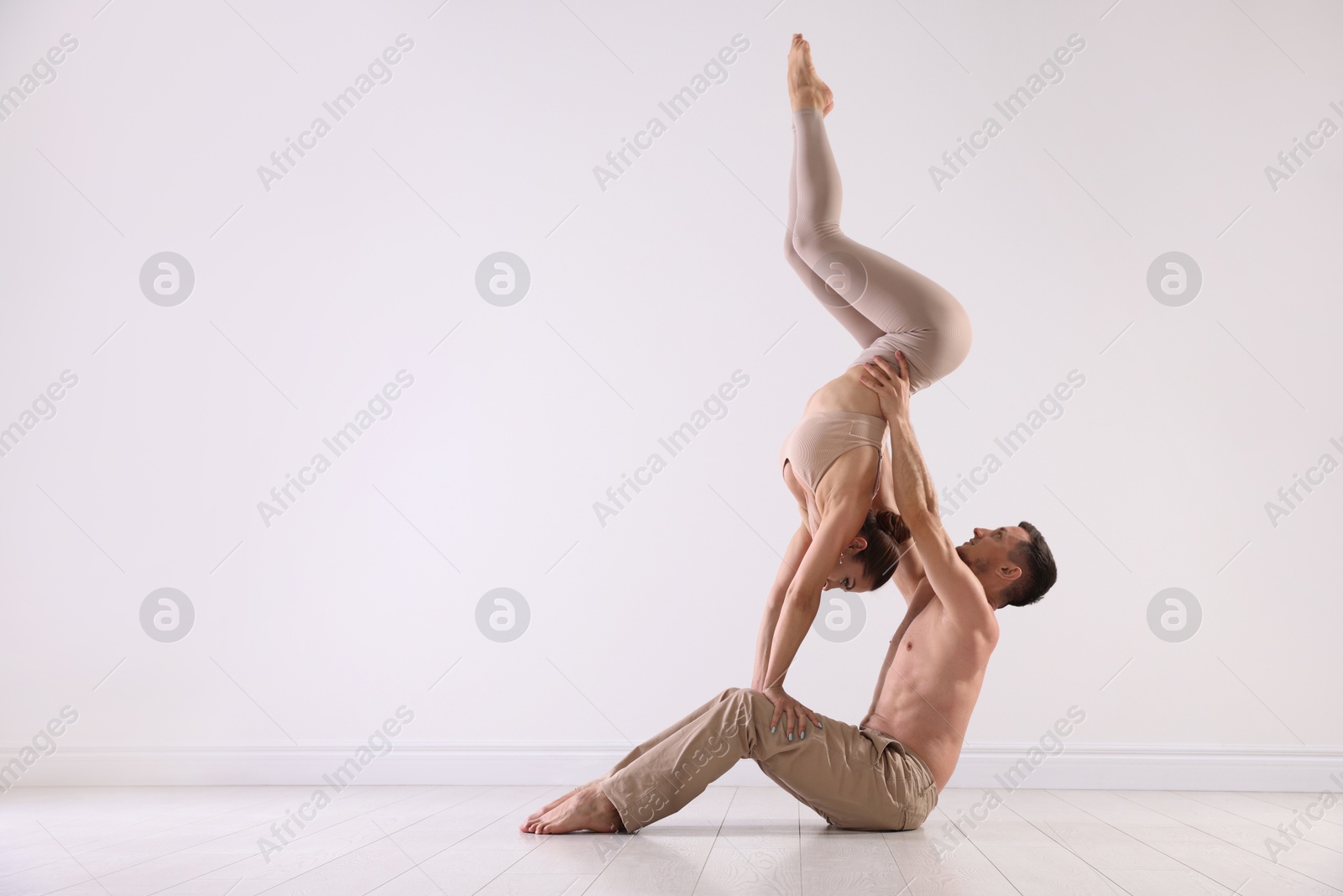 Photo of Couple of professional dancers training in studio. Space for text