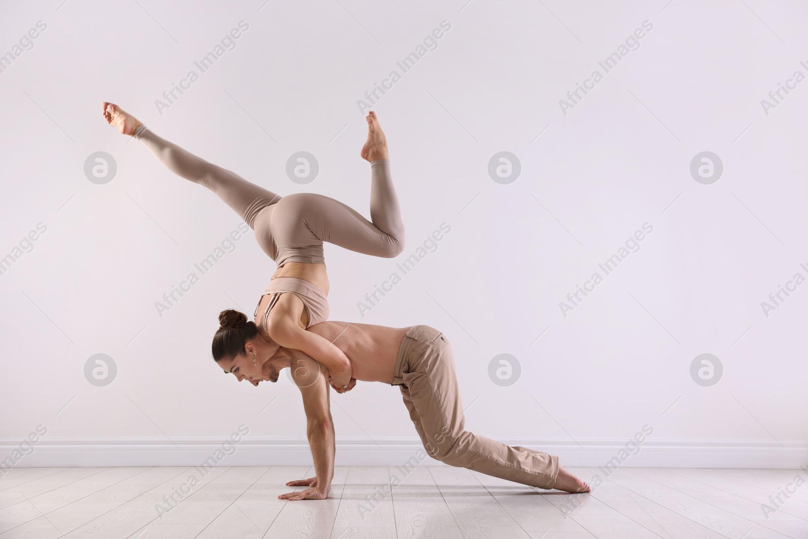 Photo of Couple of professional dancers training in studio. Space for text
