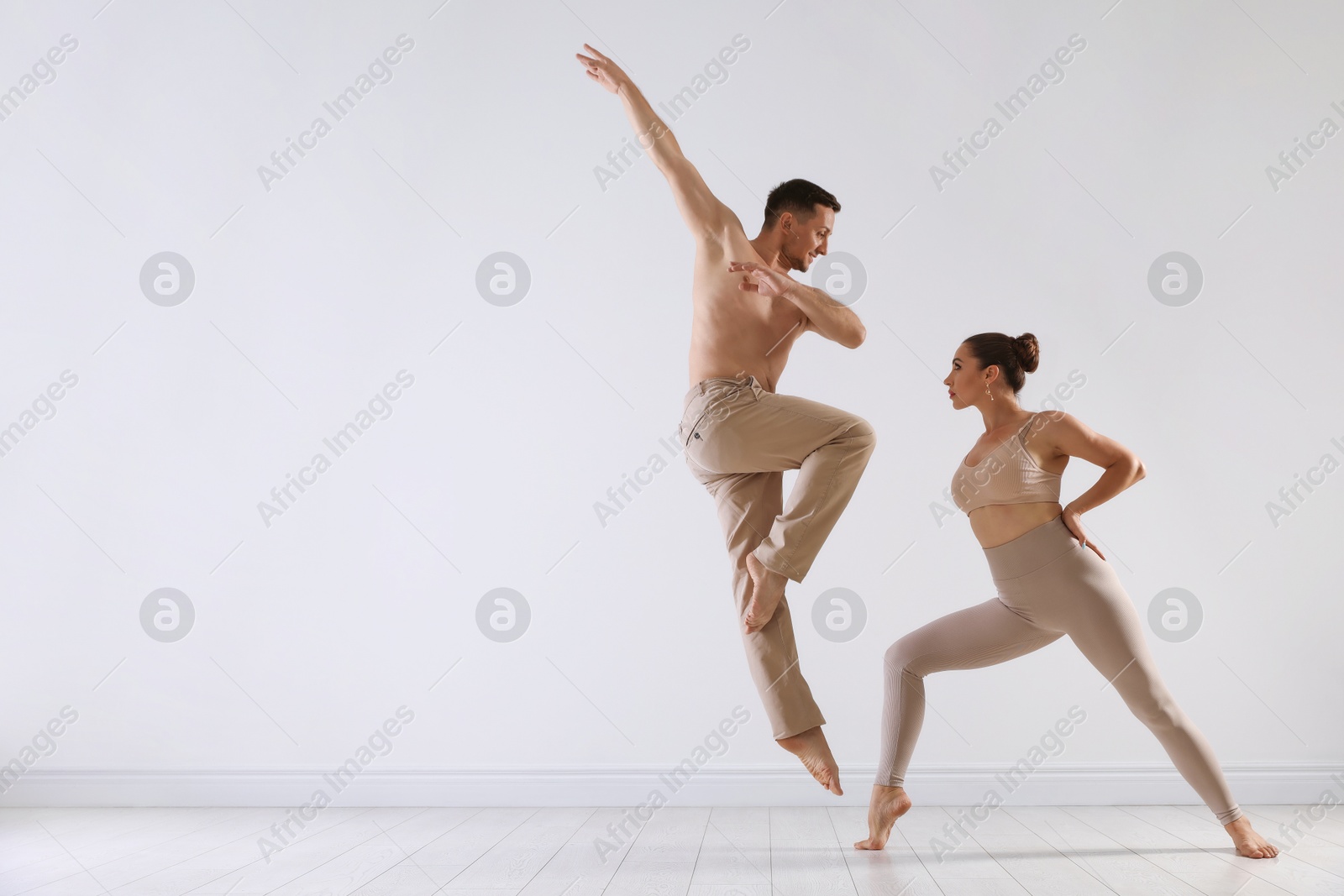 Couple of professional dancers training in studio. Space for text Photo of Couple of professional dancers training in studio. Space for text