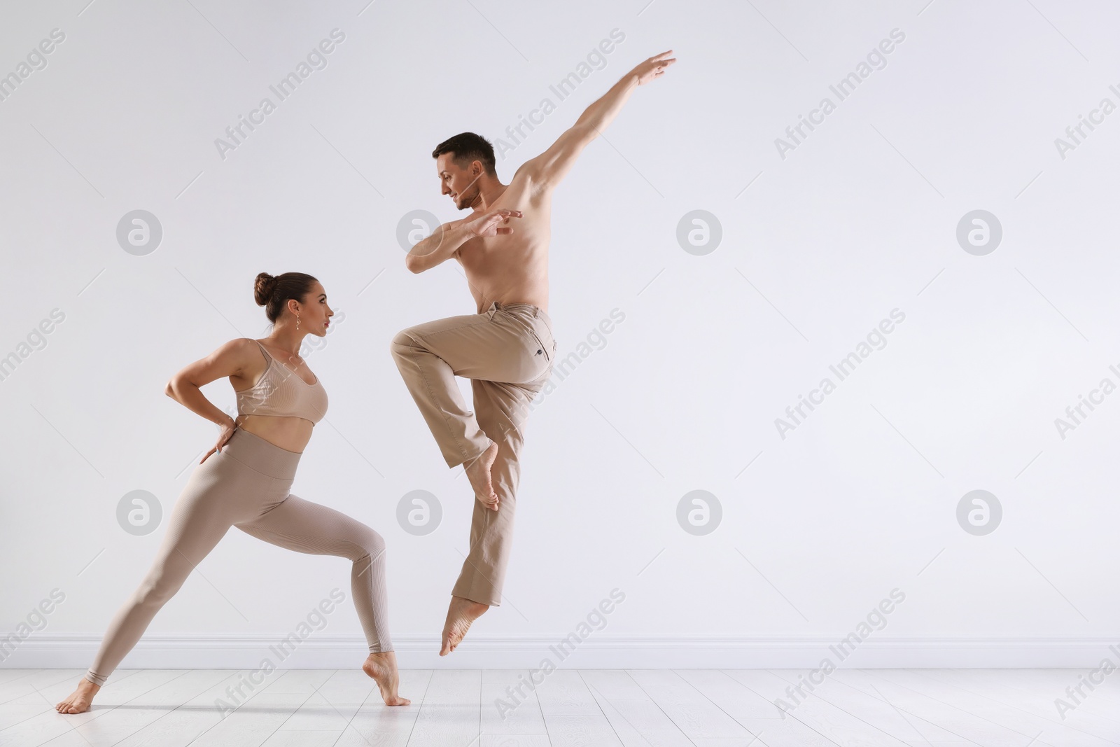 Couple of professional dancers training in studio. Space for text Photo of Couple of professional dancers training in studio. Space for text