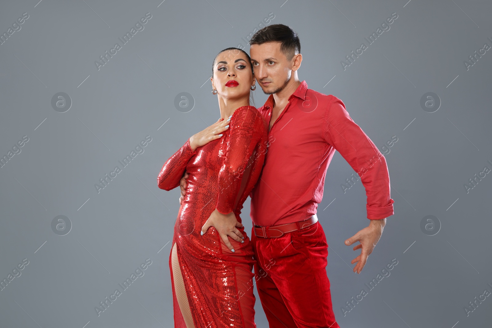 Couple of professional dancers on gray background Photo of Couple of professional dancers on gray background