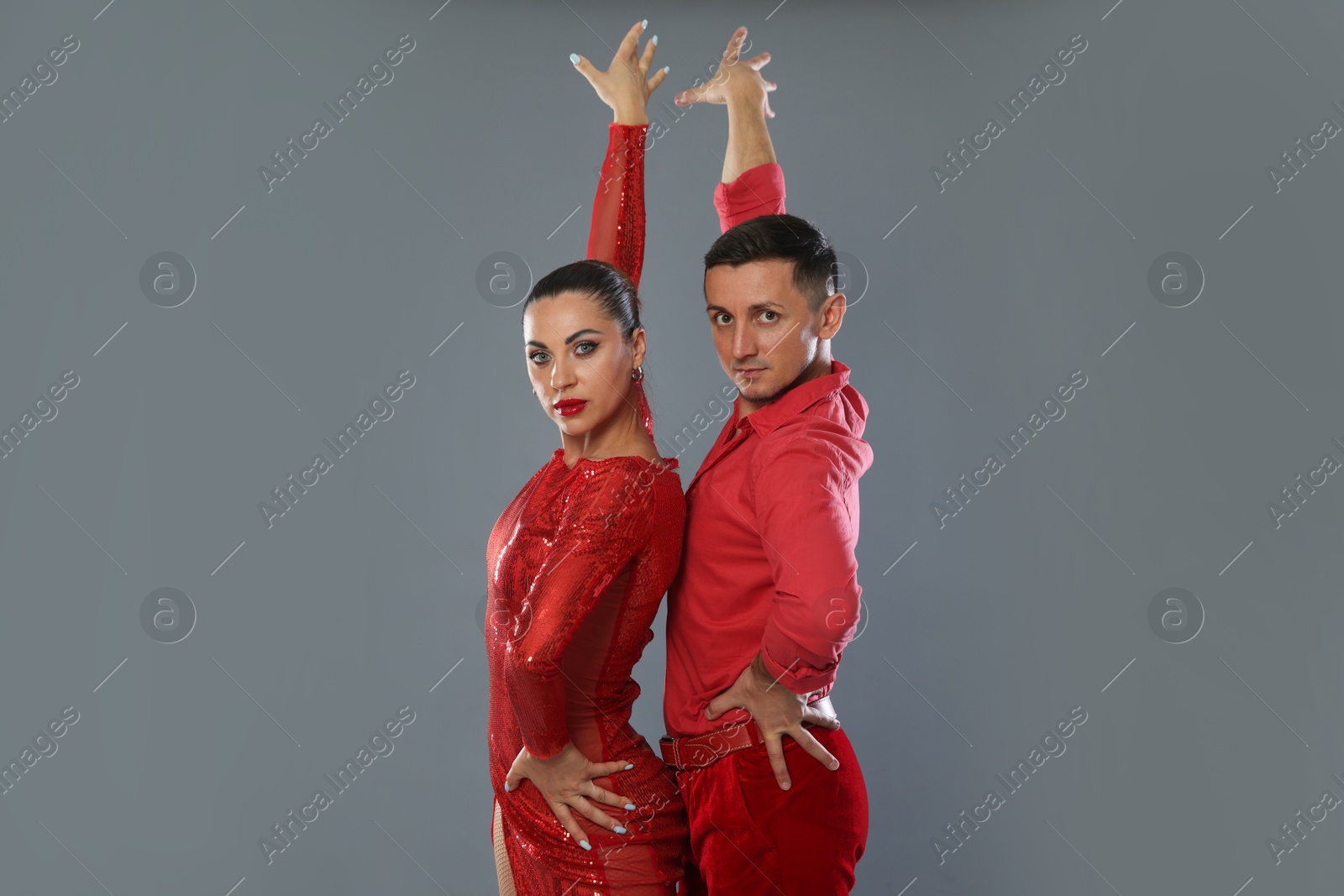 Couple of professional dancers on gray background Photo of Couple of professional dancers on gray background