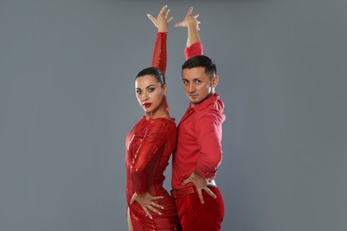 Photo of Couple of professional dancers on gray background