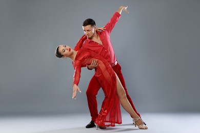 Photo of Couple of professional dancers on gray background