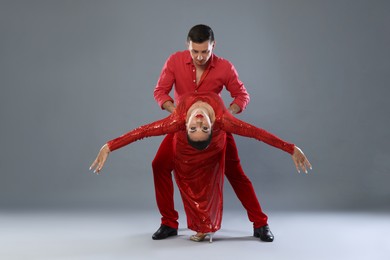 Photo of Couple of professional dancers on gray background