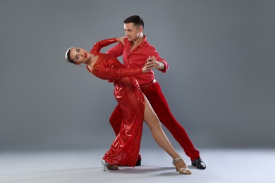 Photo of Couple of professional dancers on gray background