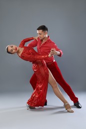 Photo of Couple of professional dancers on gray background