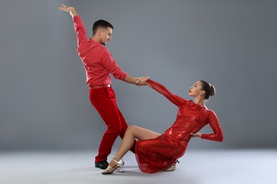 Photo of Couple of professional dancers on gray background