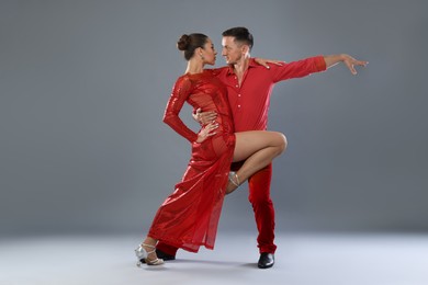 Photo of Couple of professional dancers on gray background
