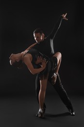 Photo of Couple of professional dancers on dark background