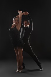 Photo of Couple of professional dancers on dark background
