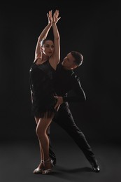 Photo of Couple of professional dancers on dark background