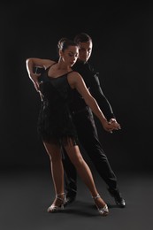 Photo of Couple of professional dancers on dark background