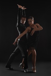 Photo of Couple of professional dancers on dark background