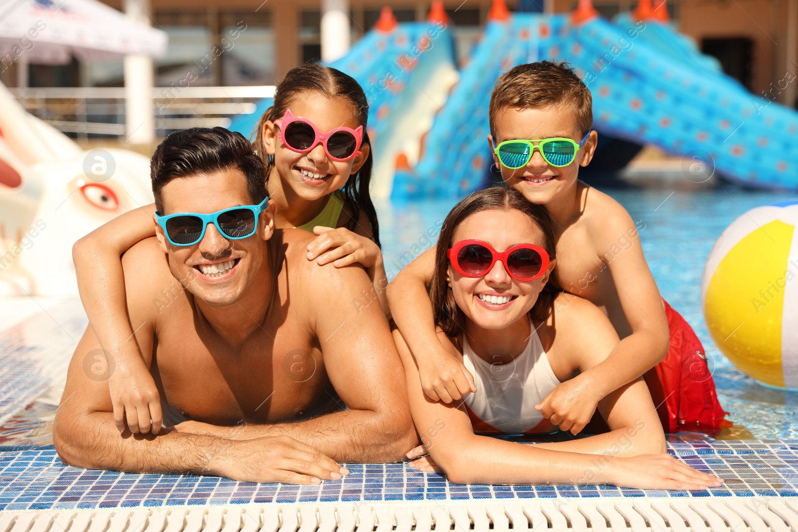 Happy family in swimming pool. Summer vacation Photo of Happy family in swimming pool. Summer vacation