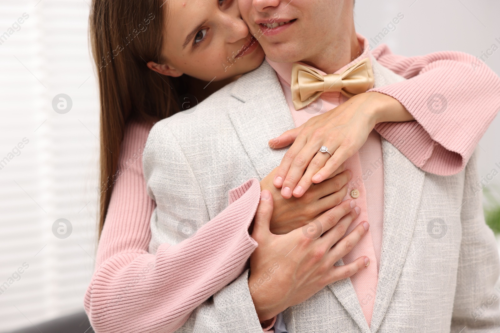 Making marriage proposal. Woman with engagement ring and her smiling fiance hugging at home, closeup Photo of Making marriage proposal. Woman with engagement ring and her smiling fiance hugging at home, closeup