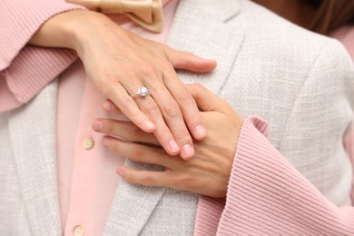 Photo of Making marriage proposal. Woman with engagement ring and her fiance hugging, closeup