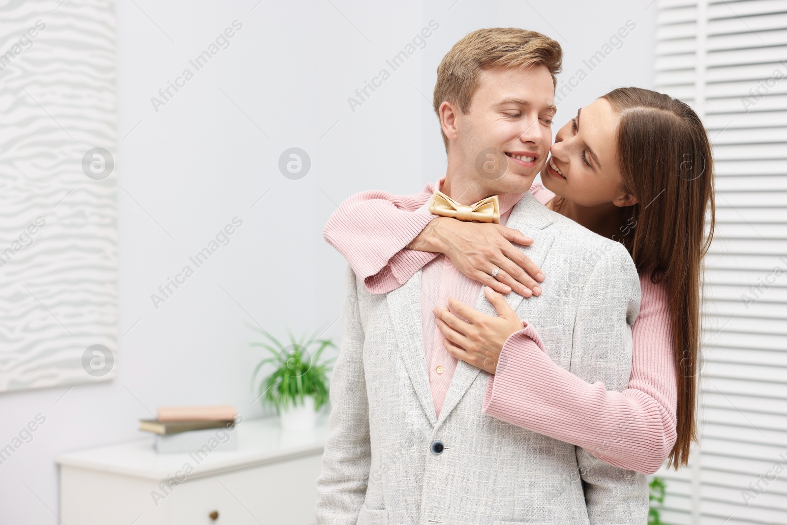Making marriage proposal. Woman with engagement ring and her smiling fiance hugging in light room. Space for text Photo of Making marriage proposal. Woman with engagement ring and her smiling fiance hugging in light room. Space for text