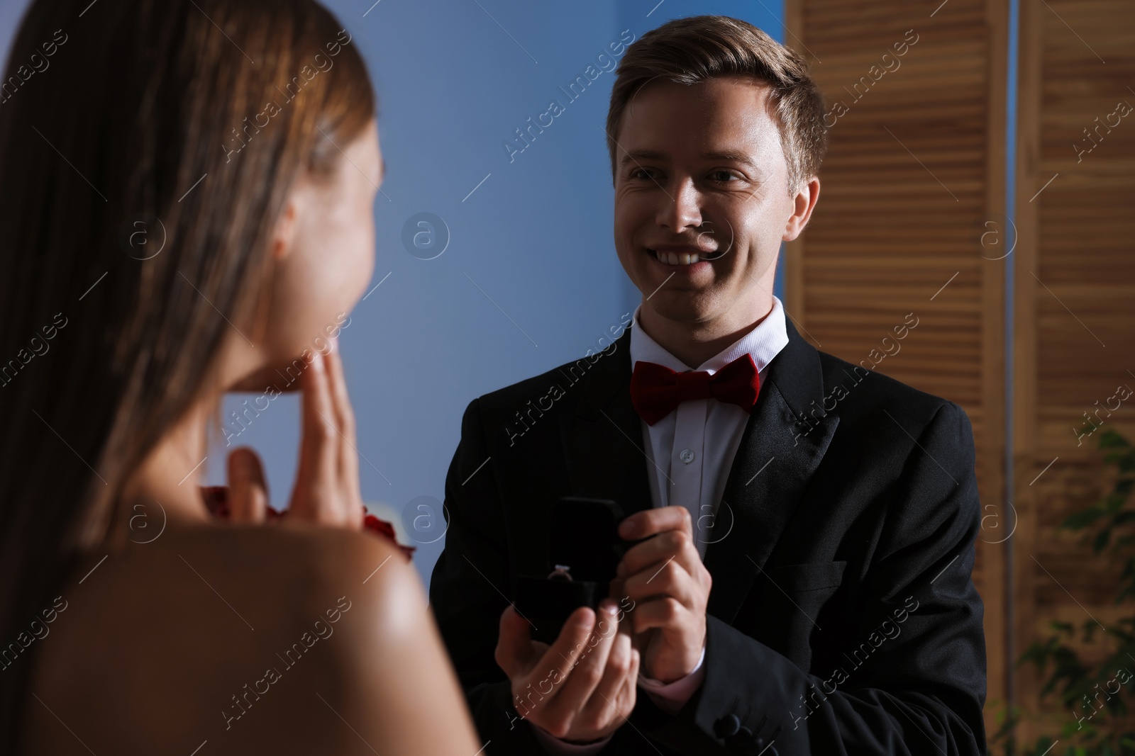 Smiling man with engagement ring making marriage proposal to his girlfriend at home Photo of Smiling man with engagement ring making marriage proposal to his girlfriend at home