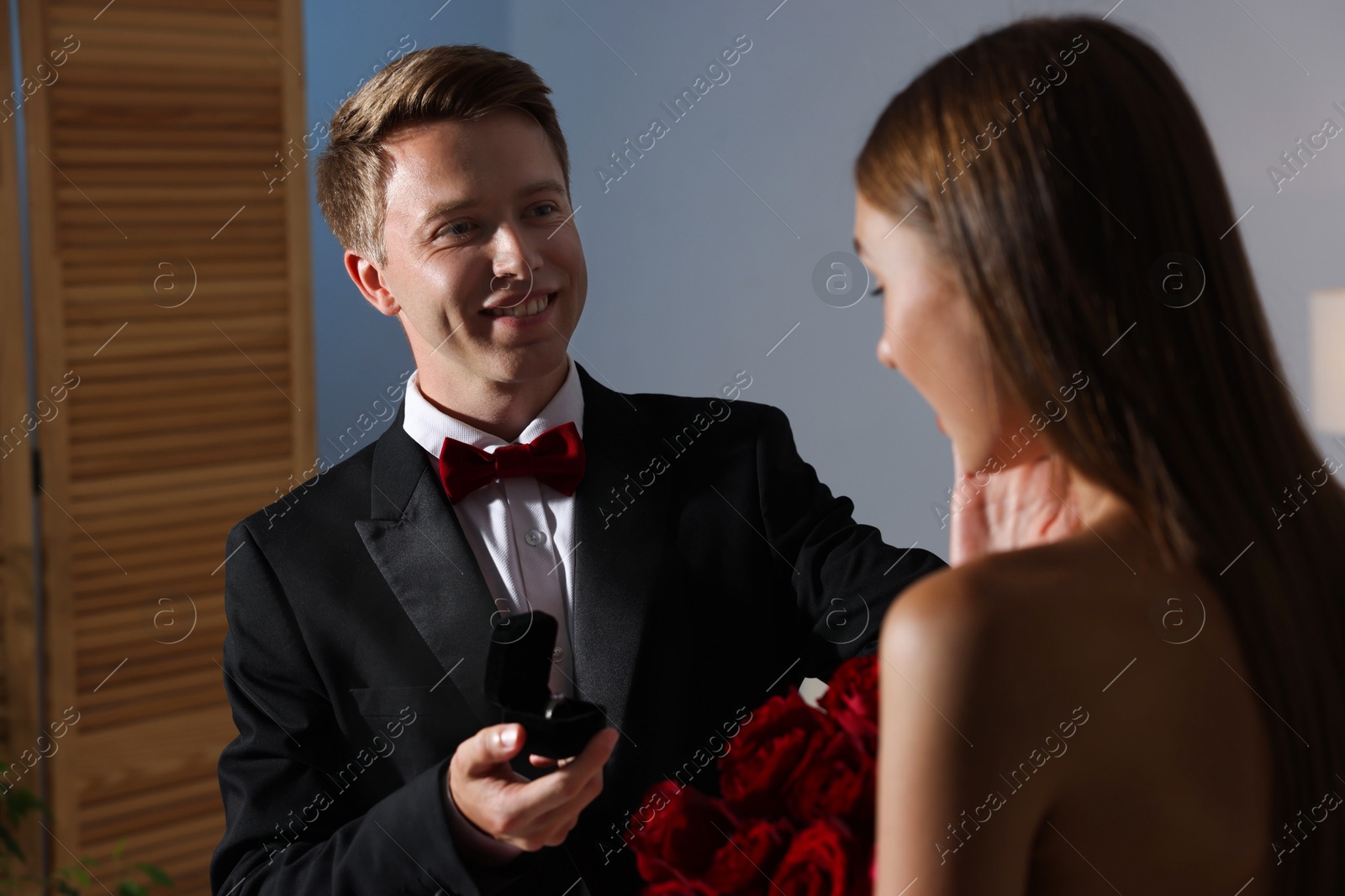Smiling man with engagement ring making marriage proposal to his girlfriend at home Photo of Smiling man with engagement ring making marriage proposal to his girlfriend at home