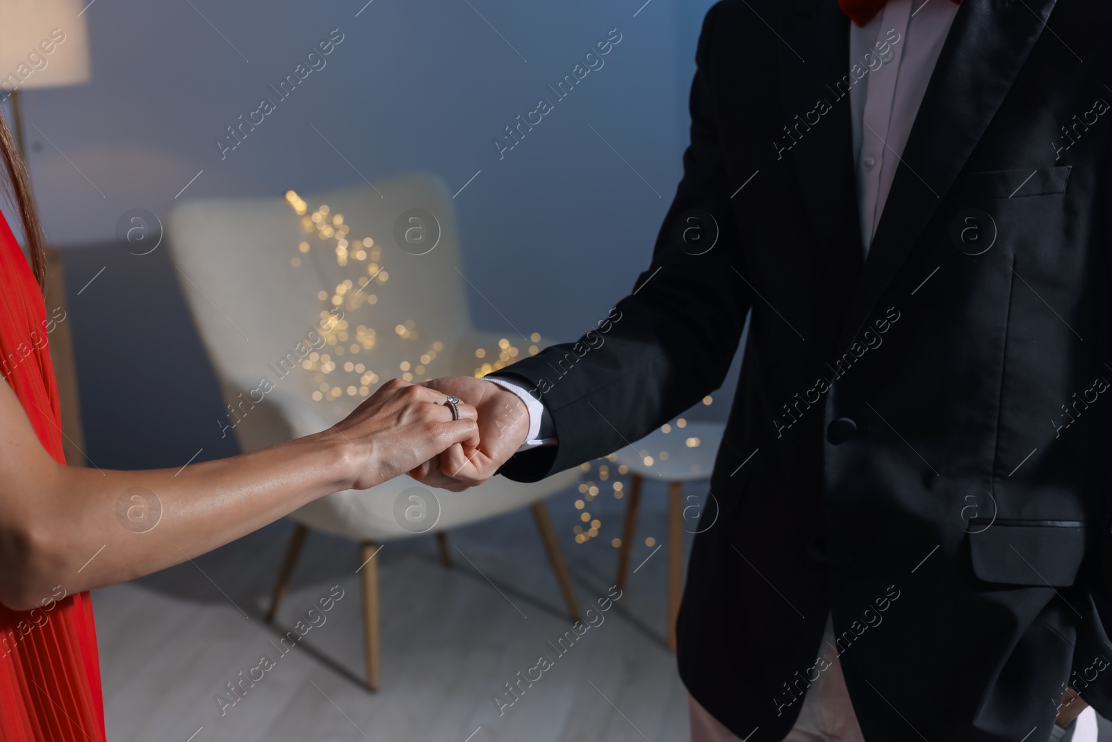 Making marriage proposal. Woman with engagement ring and her fiance holding hands at home, closeup. Bokeh effect Photo of Making marriage proposal. Woman with engagement ring and her fiance holding hands at home, closeup. Bokeh effect
