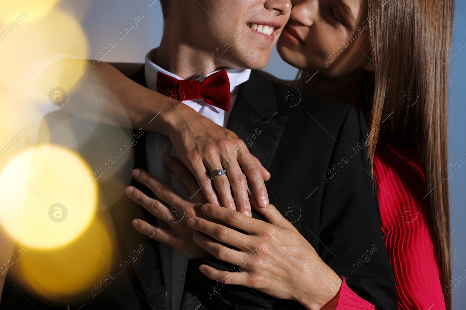 Making marriage proposal. Woman with engagement ring and her smiling fiance hugging at home, closeup. Bokeh effect Photo of Making marriage proposal. Woman with engagement ring and her smiling fiance hugging at home, closeup. Bokeh effect