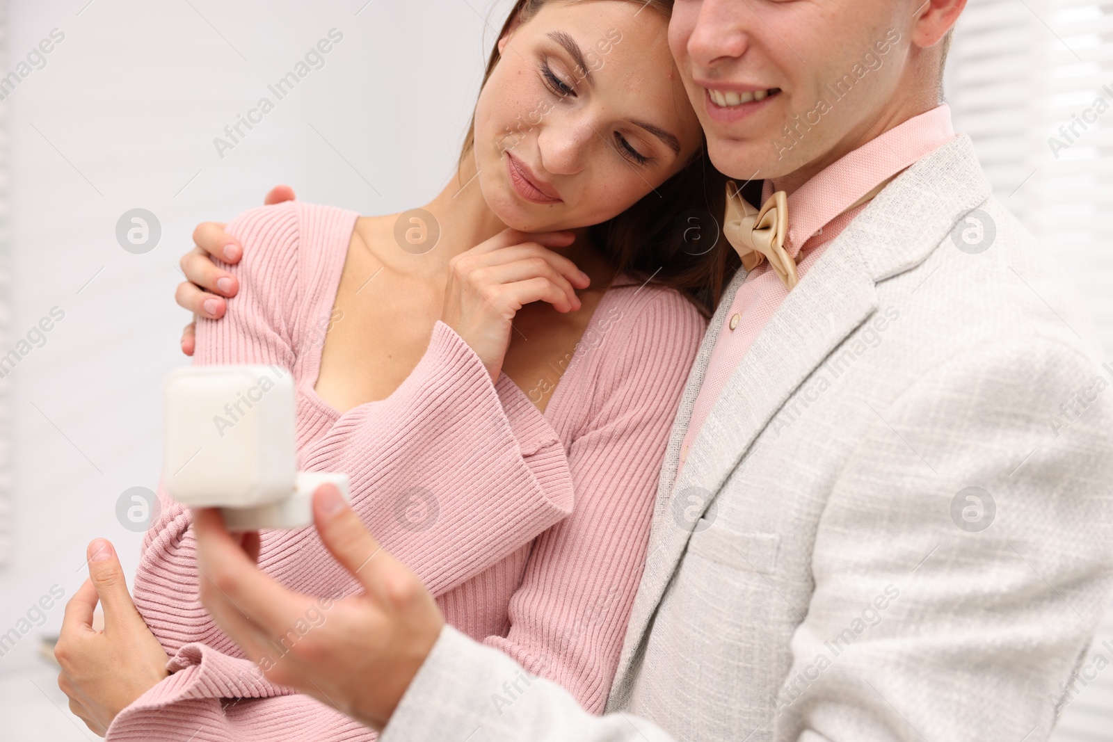 Marriage proposal. Smiling man with engagement ring and his girlfriend at home, closeup Photo of Marriage proposal. Smiling man with engagement ring and his girlfriend at home, closeup