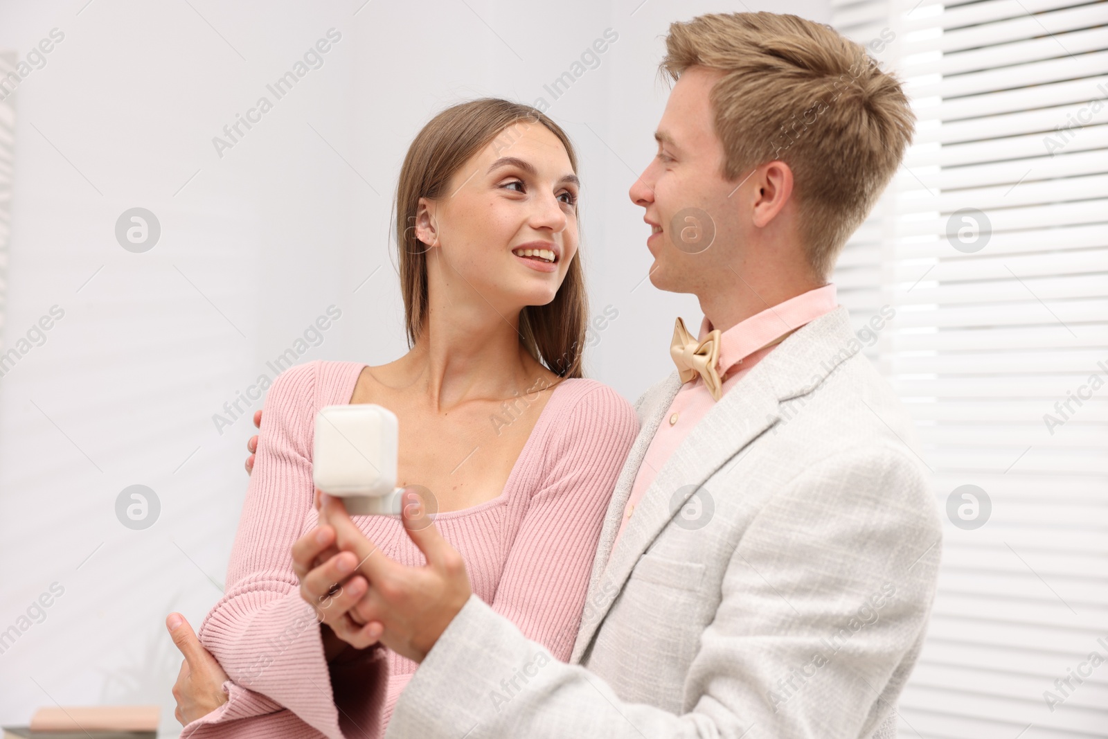 Marriage proposal. Smiling man with engagement ring and his happy girlfriend at home Photo of Marriage proposal. Smiling man with engagement ring and his happy girlfriend at home
